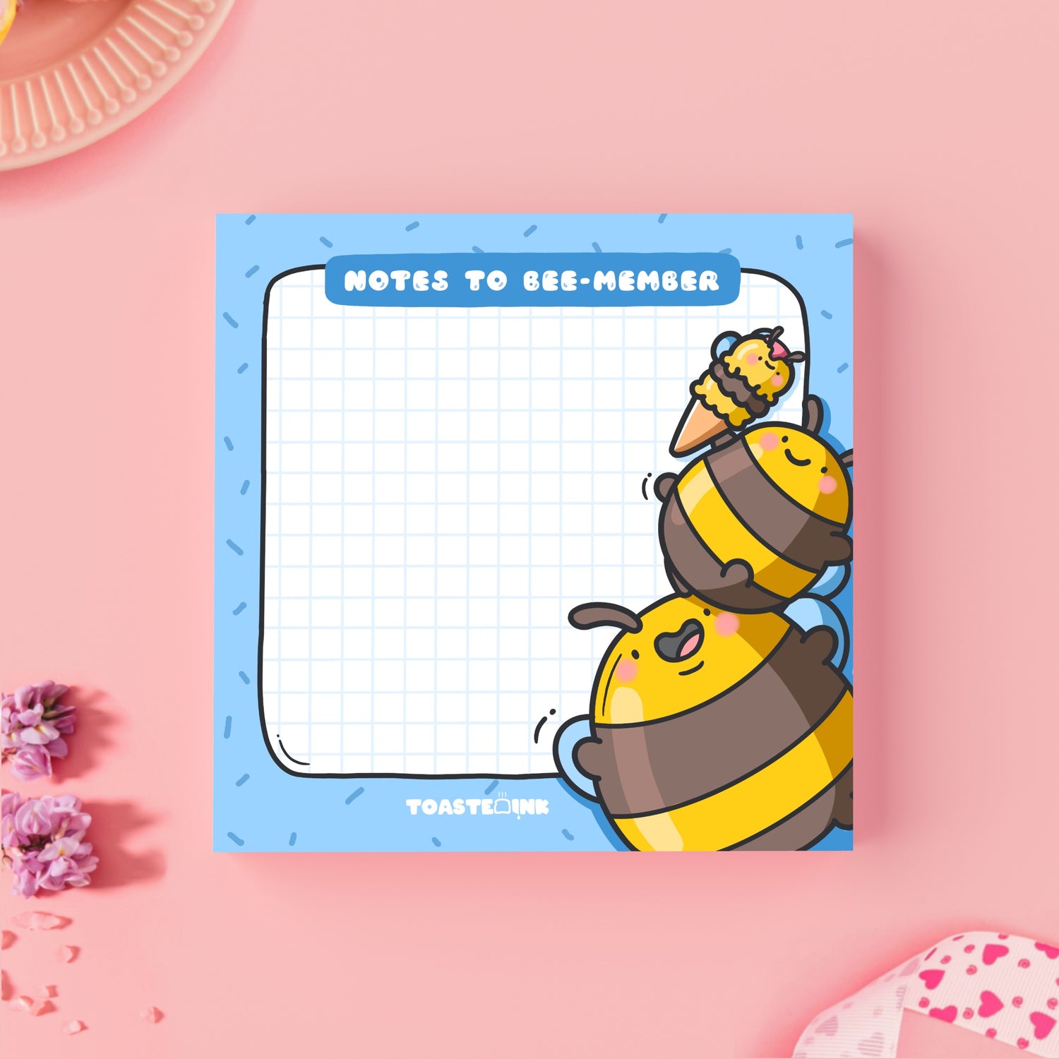 Bee sticky Notes on pink table