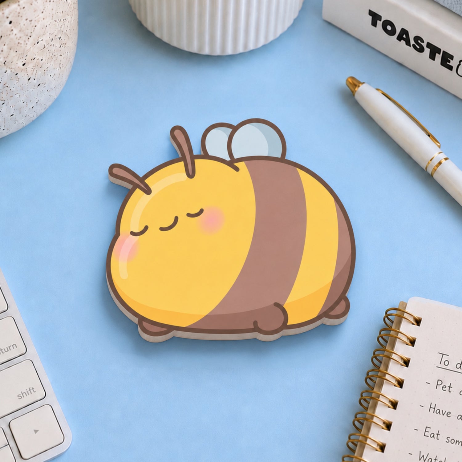 Bee sticky notes with stationery on blue table