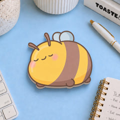 Bee sticky notes with stationery on blue table