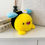 Bee plush with white cushion and books