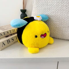 Bee plush with white cushion and books
