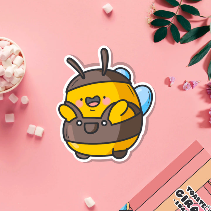 Bee wearing dungarees vinyl sticker on pink table