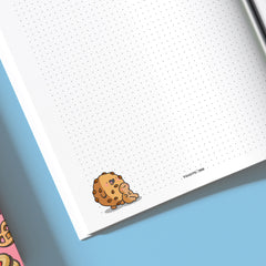 Biscuit on dot grid notebook close up