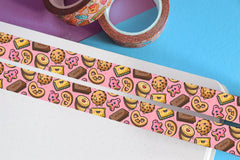 Pink biscuit washi tape on blue and purple table with washi tape rolls