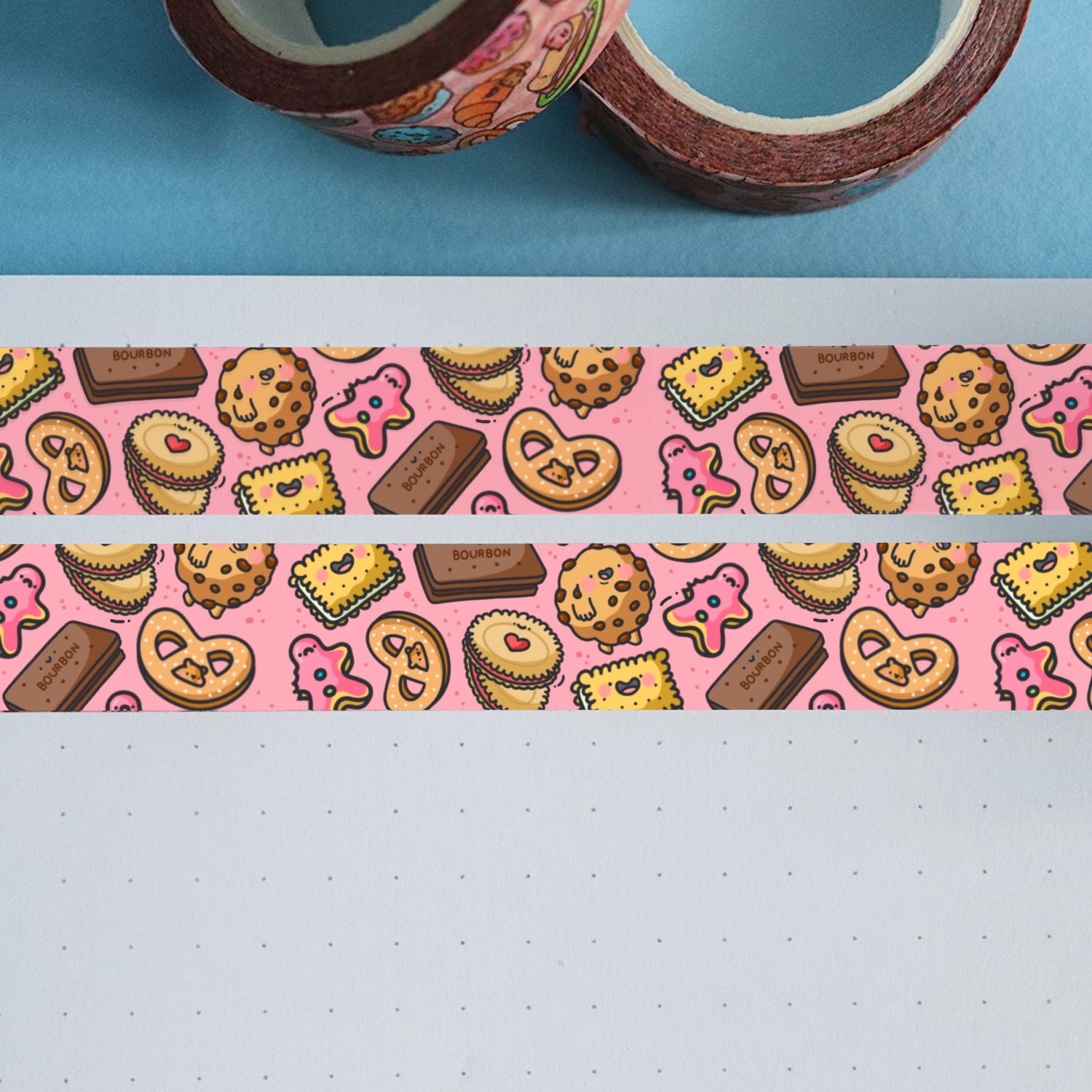 Pink biscuit washi tape on notebook and blue table