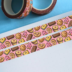 Pink biscuit washi tape on white paper and 2 rolls of washi tape rolls