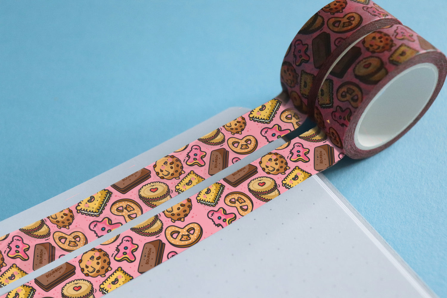2 rolls of pink biscuit washi tape on notebook