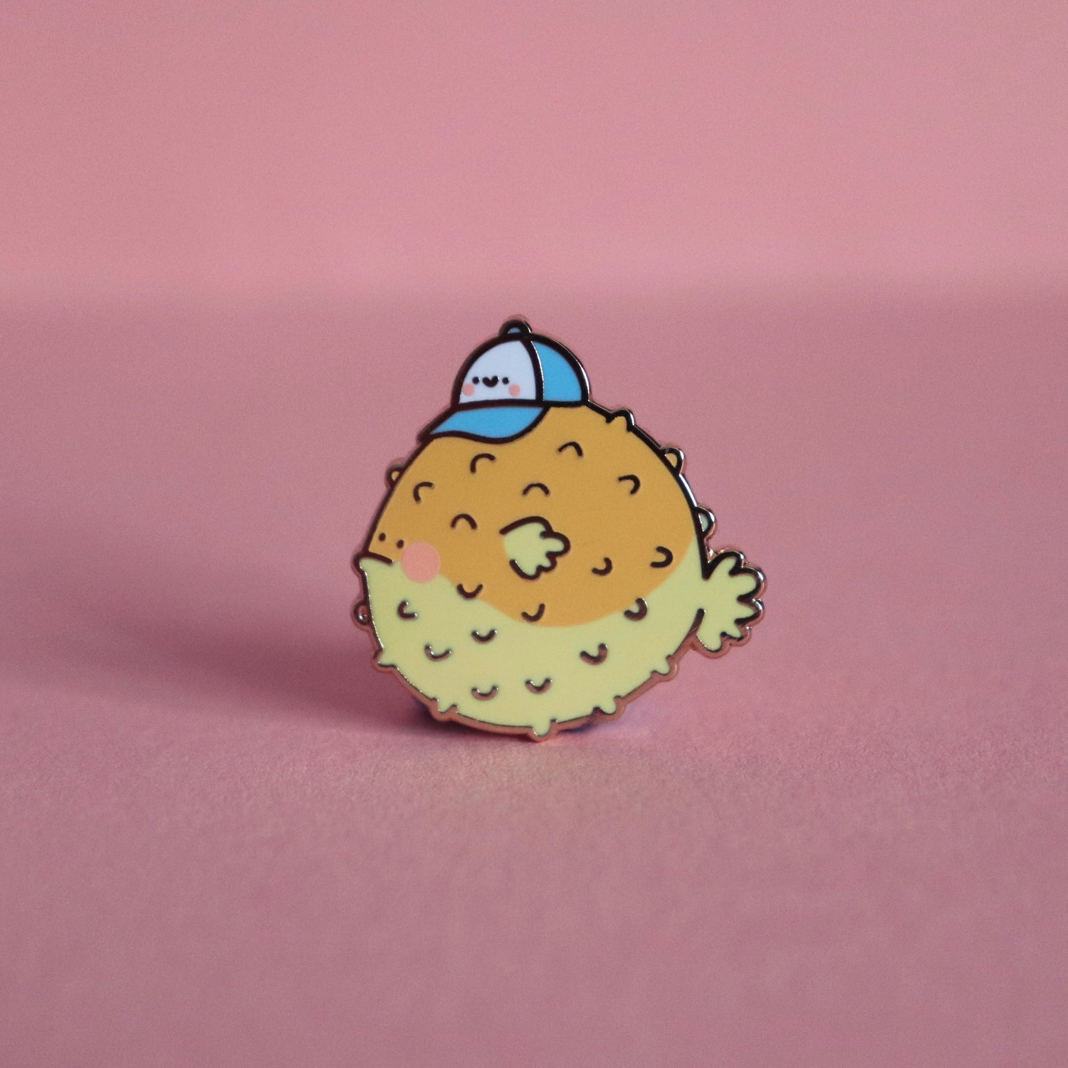 Blowfish enamel pin on pink background