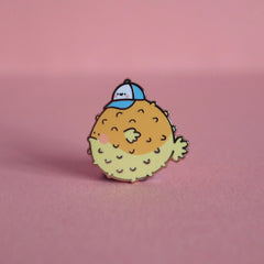 Blowfish enamel pin on pink background