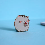 Cat enamel pin on blue background
