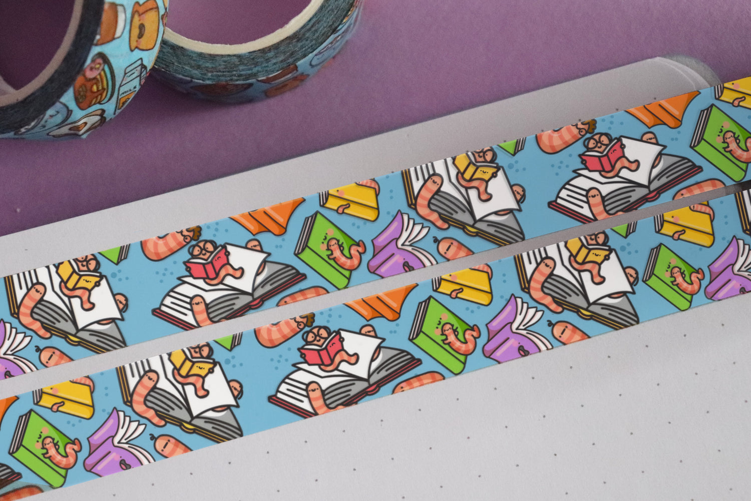 Bookworm washi tape on notebook and purple table