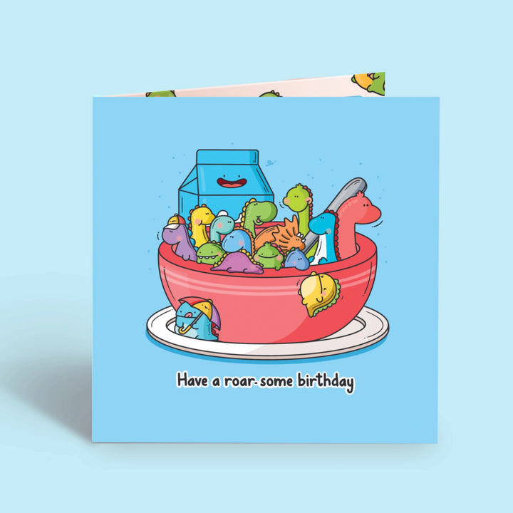 Bowl of dinosaurs Card on blue table