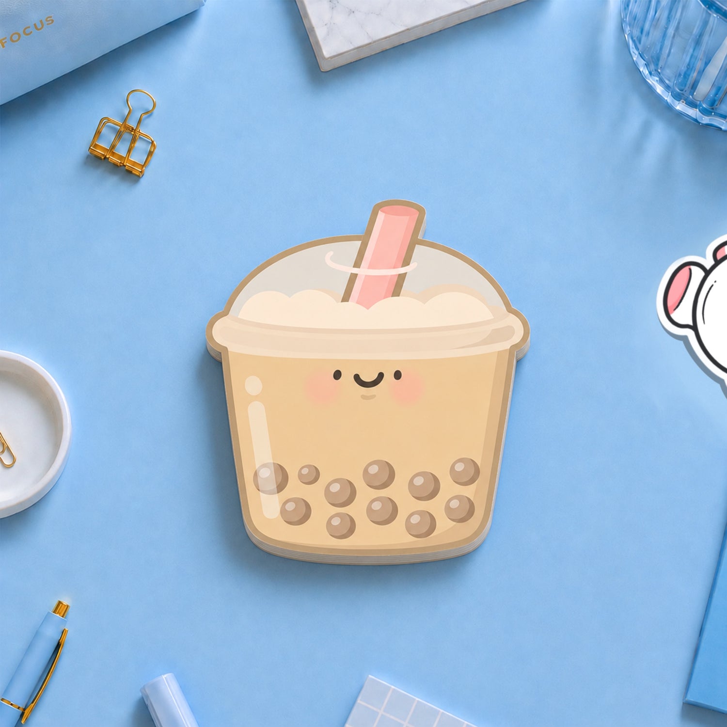 Bubble tea shaped sticky notes with stationery on blue desk