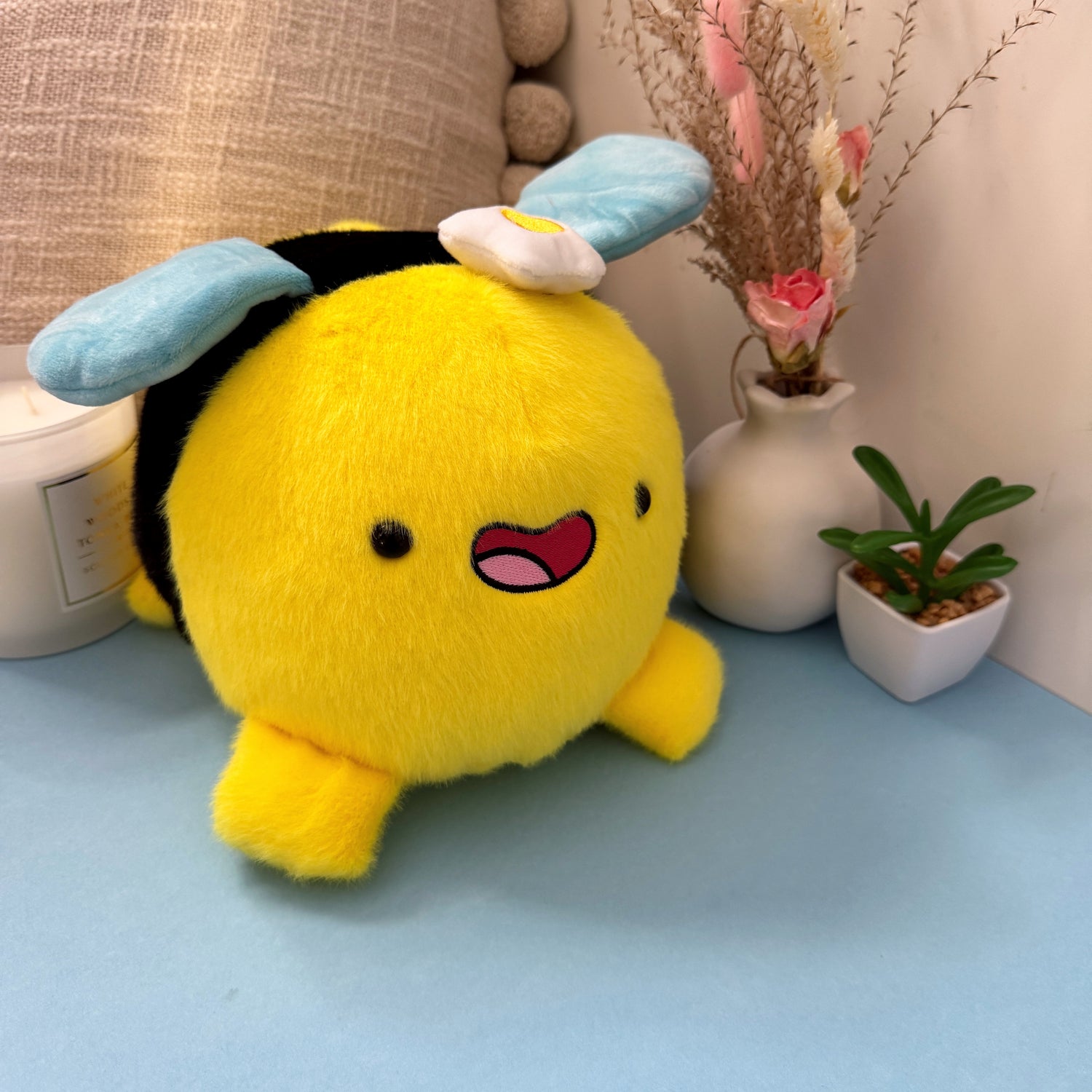 Bee plush toy on blue table