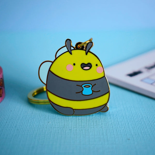 Bee keychain on blue table