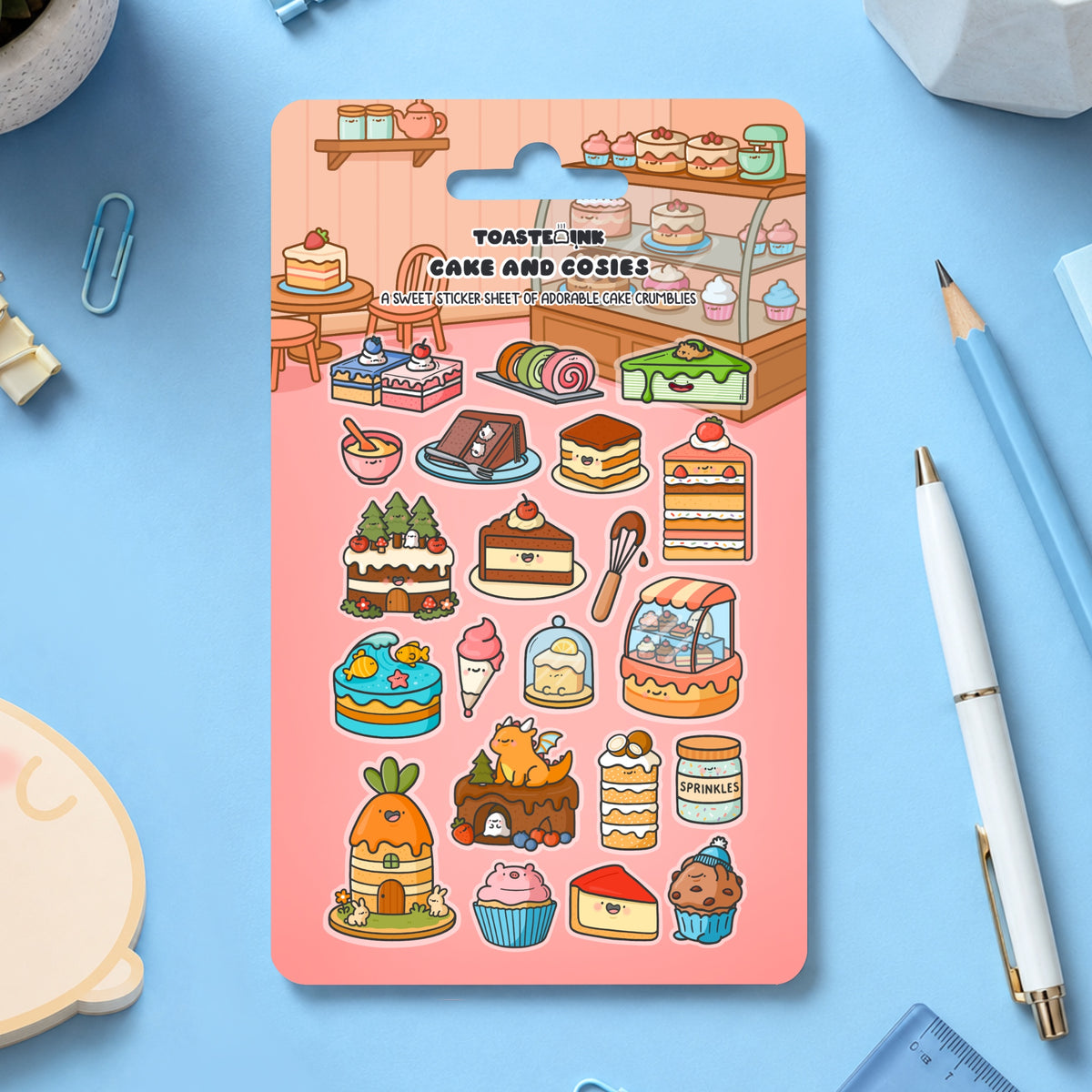 Cake sticker sheet with whimsical cake designs scattered with stationery