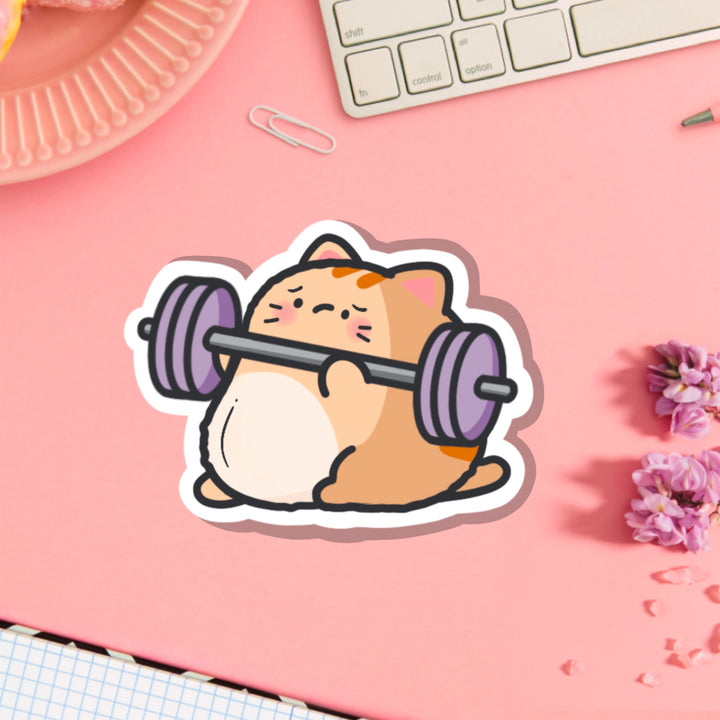 Cat lifting weights vinyl sticker on pink table