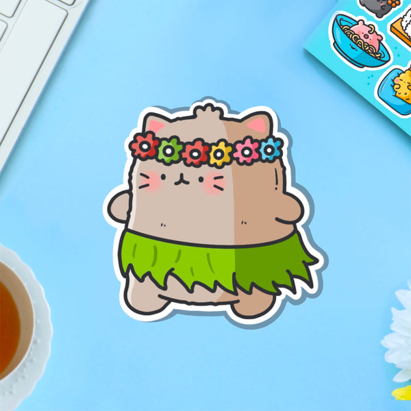 Cat in a grass skirt vinyl sticker on blue table