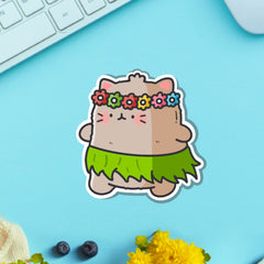 Cat in a grass skirt vinyl sticker on blue table with keyboard