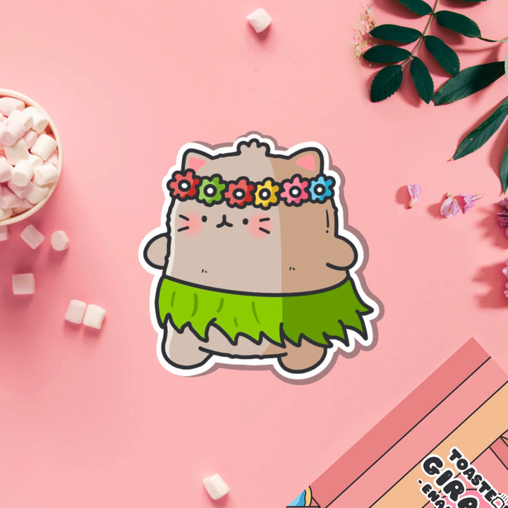 Cat in a grass skirt vinyl sticker on pink table