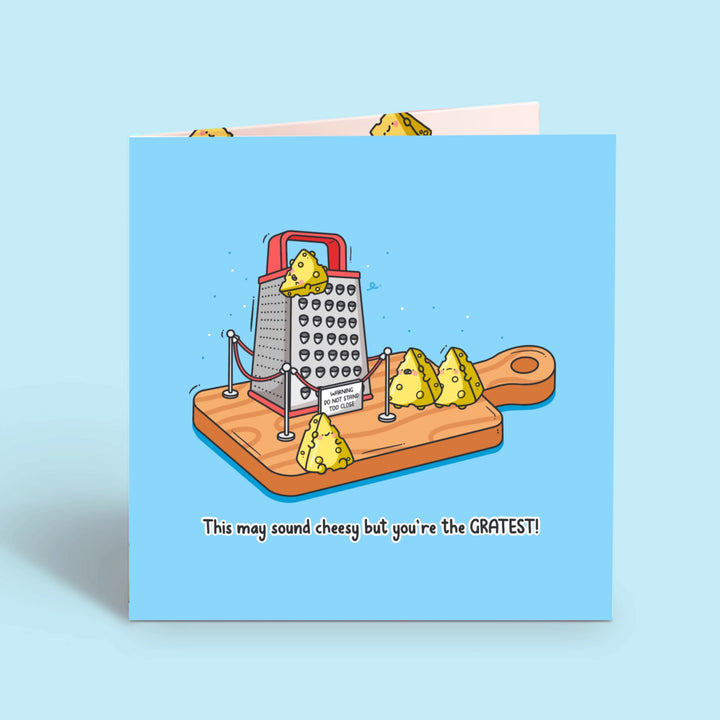 Cheese grater card on blue desk