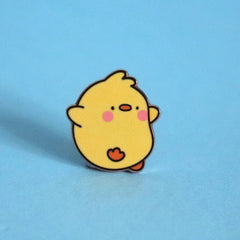 Chick enamel pin on blue desk