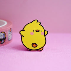 Chick enamel pin on pink table with washi tape