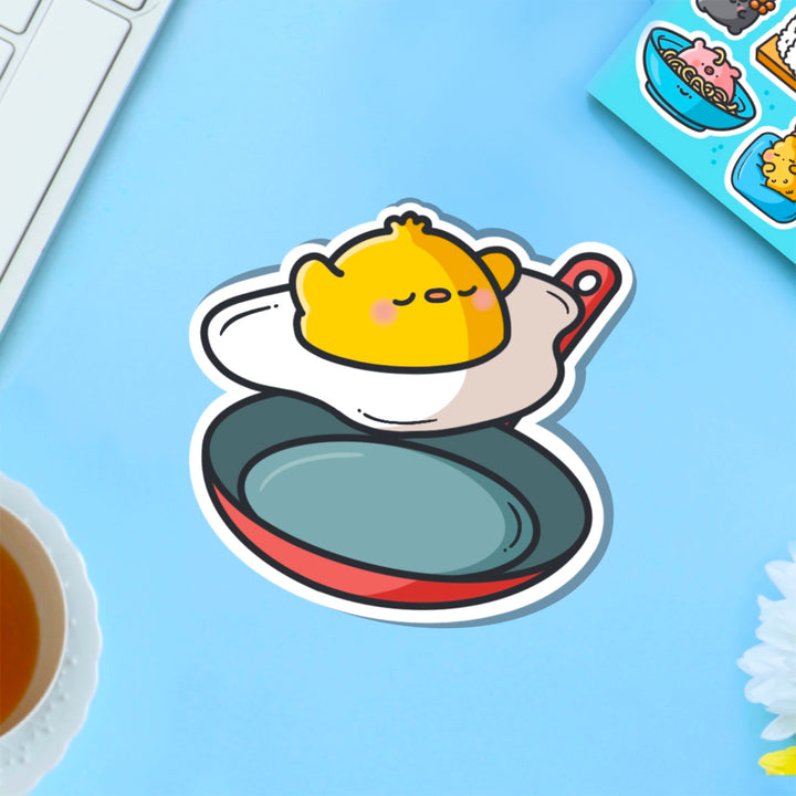 Chick as a fried egg vinyl sticker on blue table