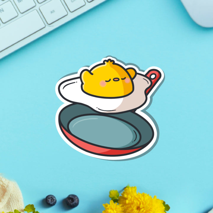 Chick as a fried egg vinyl sticker on green table