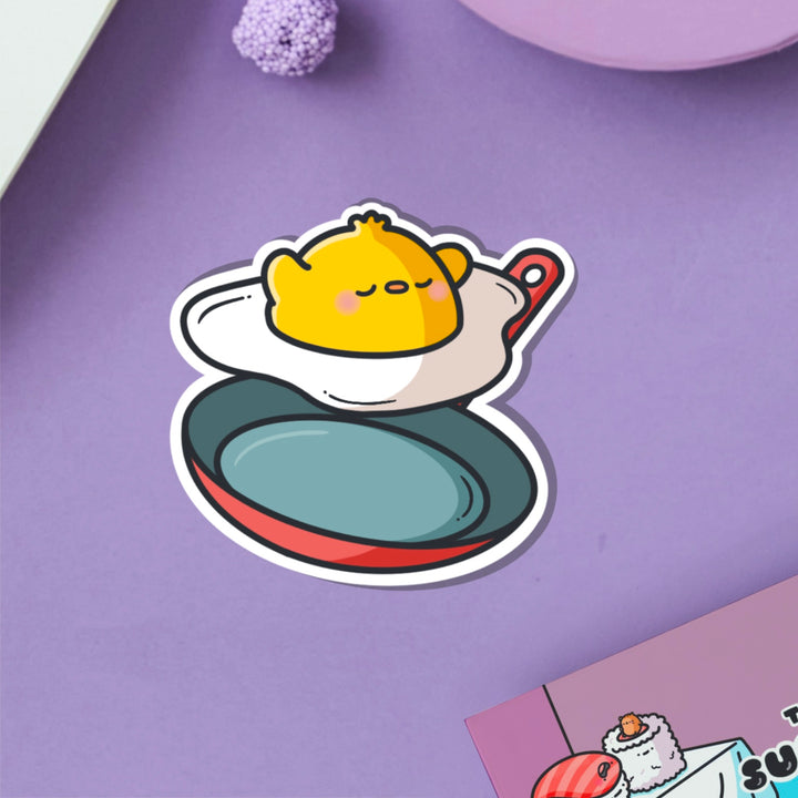 Chick as a fried egg vinyl sticker on purple table