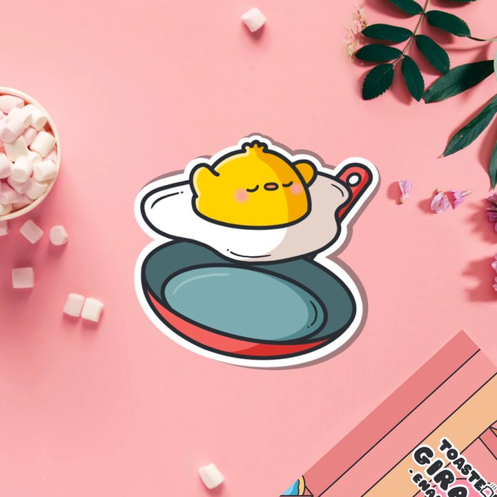 Chick as a fried egg vinyl sticker on pink table