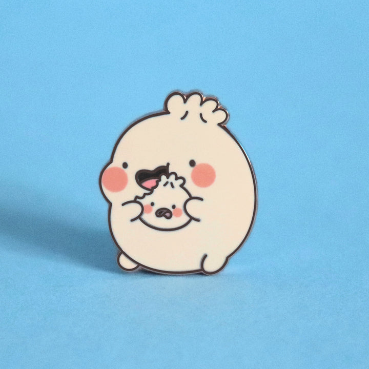 Dumpling eating enamel pin on blue background