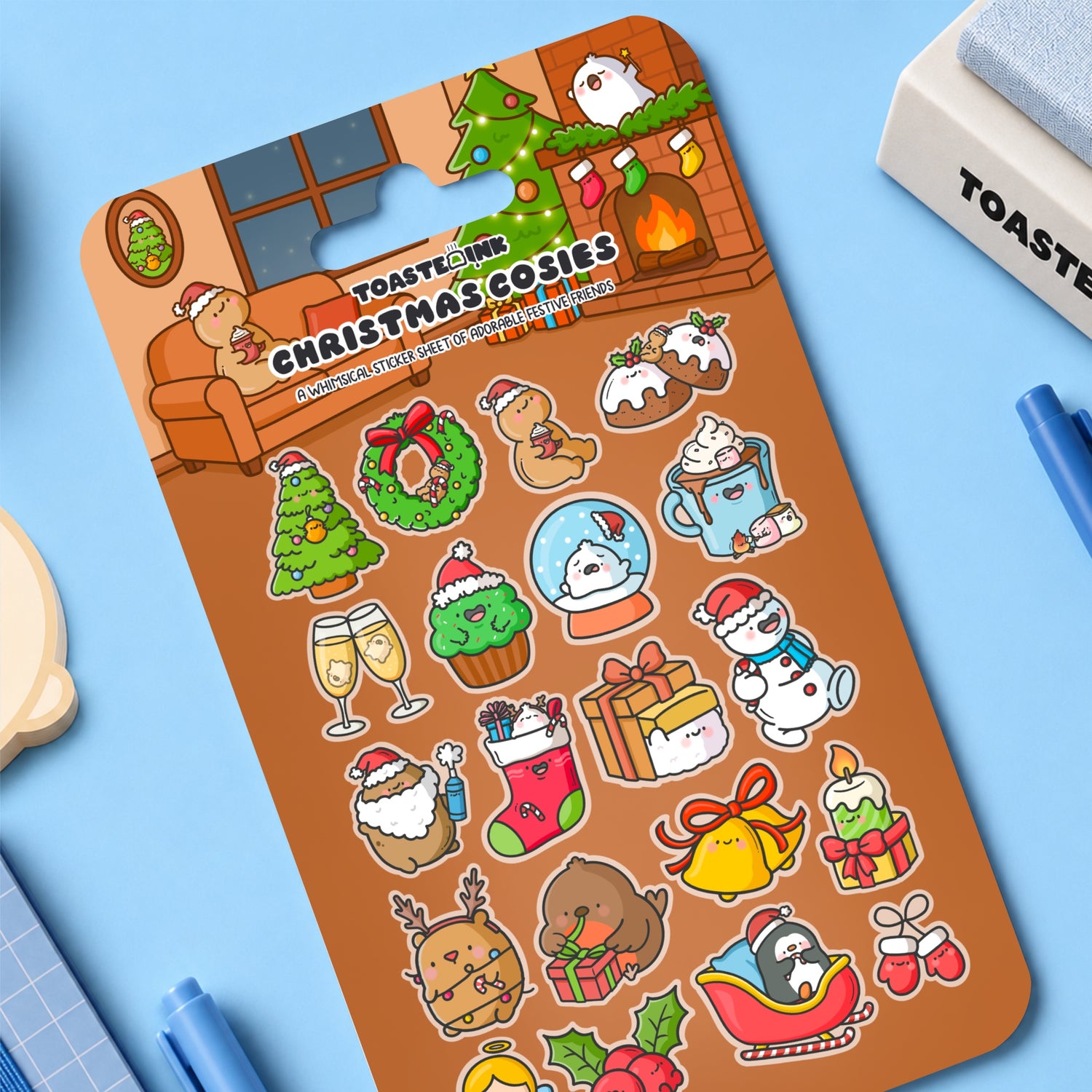 Christmas sticker sheet on desk with whimsical illustrations on blue desk