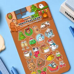 Christmas sticker sheet on desk with whimsical illustrations on blue desk