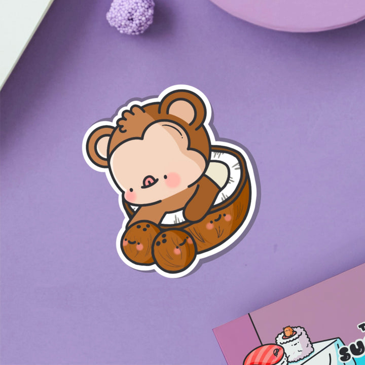 Monkey in a coconut vinyl sticker on purple