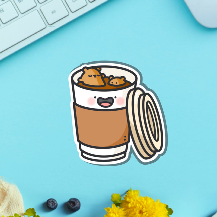 Bear in a coffee cup vinyl sticker on blue table with keyboard