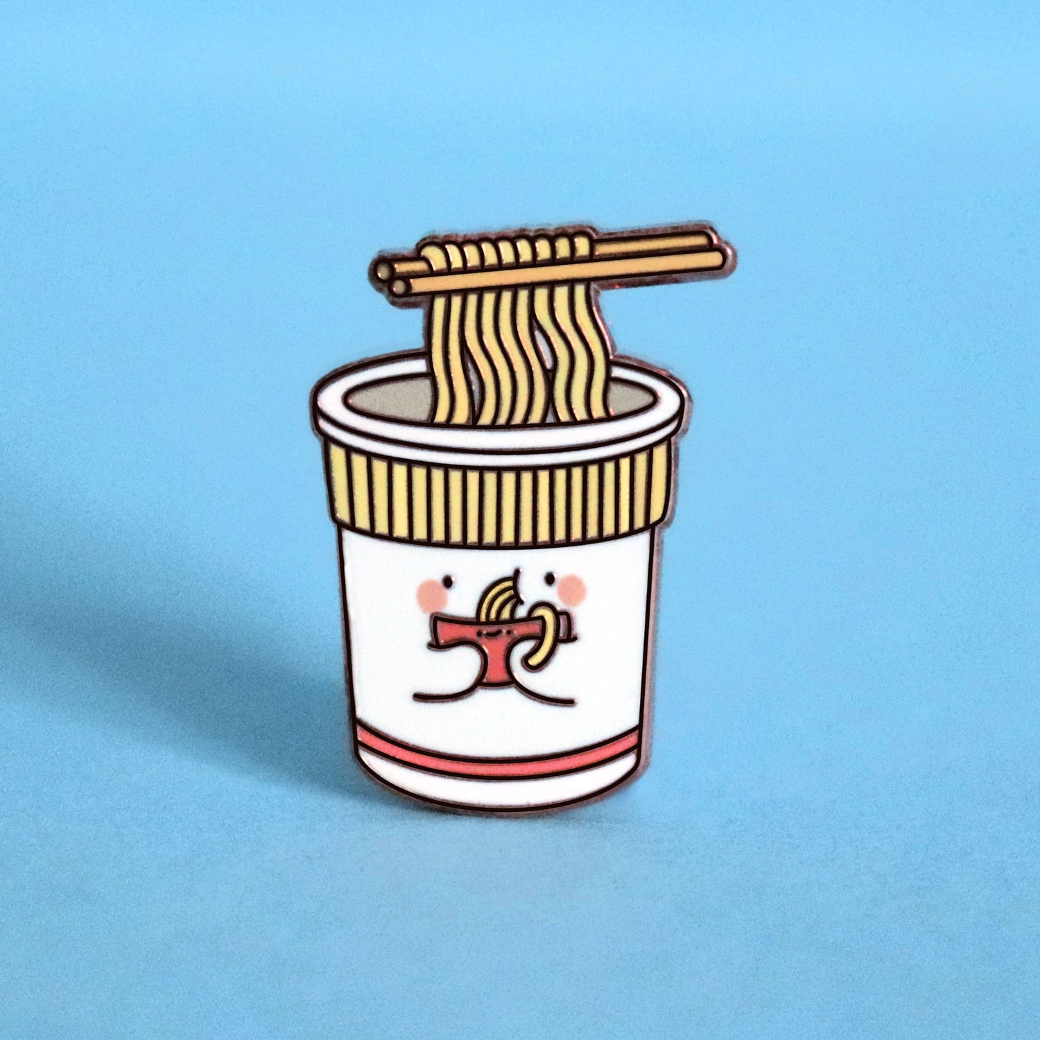 Cup noodles eating bowl of noodles enamel pin on blue desk
