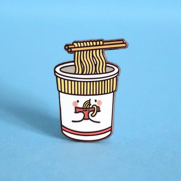 Cup noodles eating bowl of noodles enamel pin on blue desk