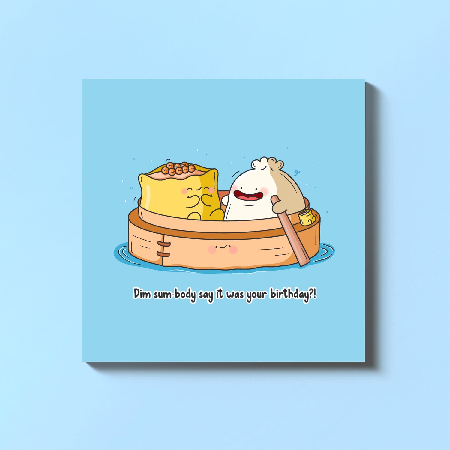 Dim sum steamer boat birthday card on blue table