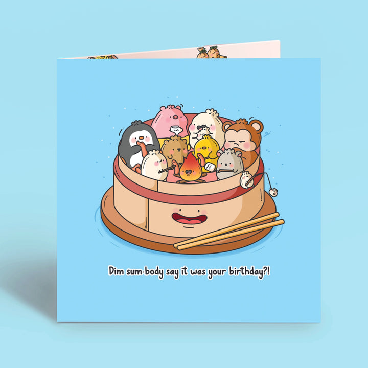 Dim sum campfire birthday card on blue table