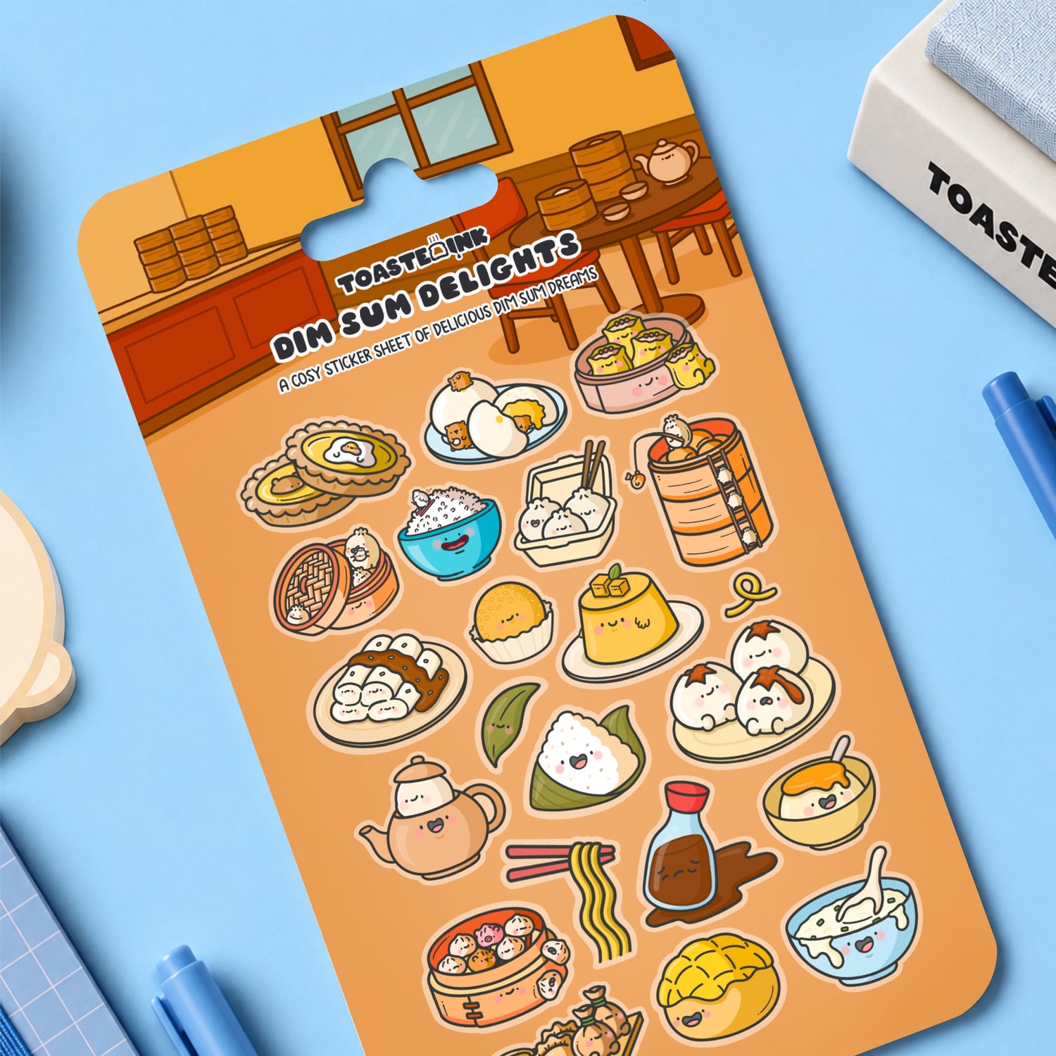 Dim sum sticker sheet on blue desk with stationery around