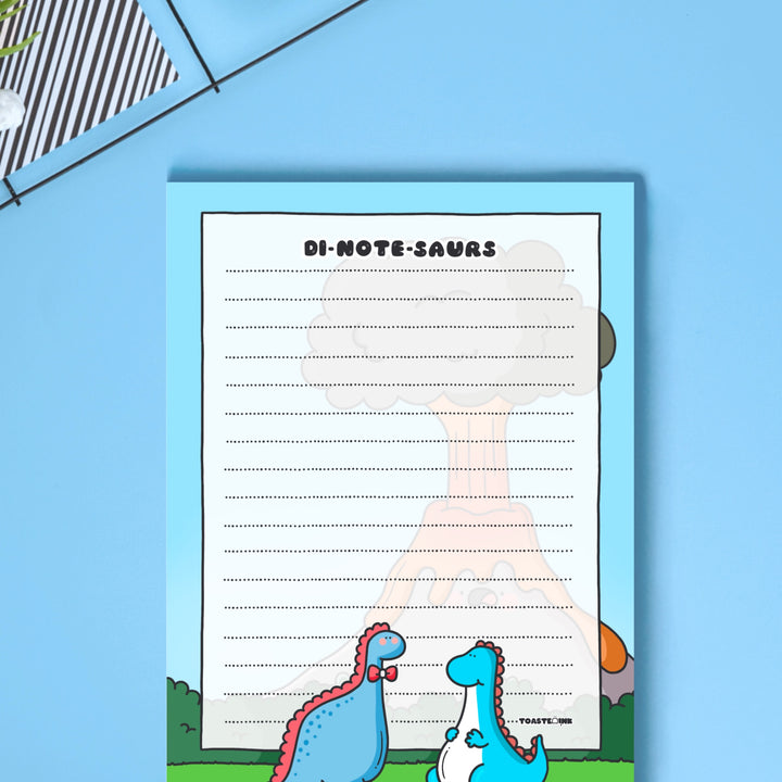 A6 Dinosaur Notepad on blue table close up