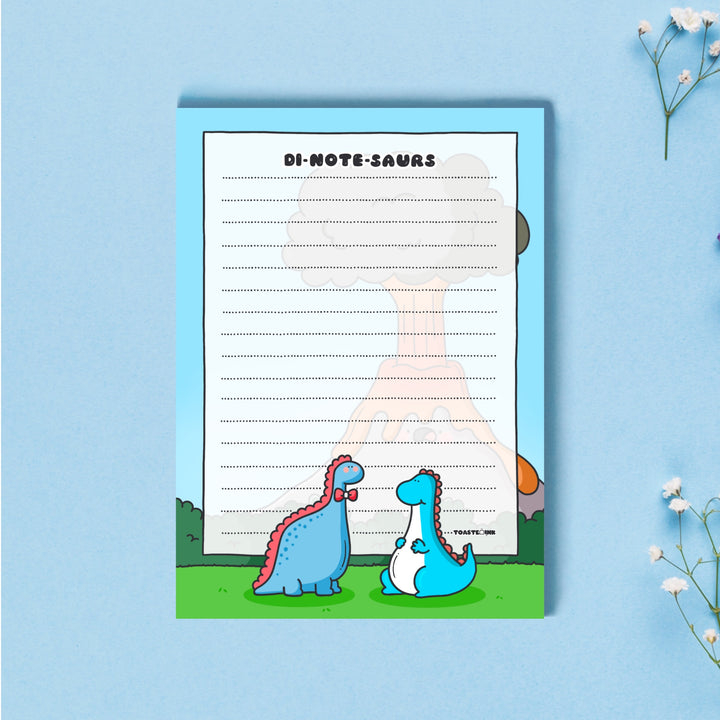 A6 Dinosaur Notepad on blue desk