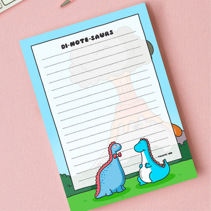 A6 Dinosaur Notepad on pink desk close up