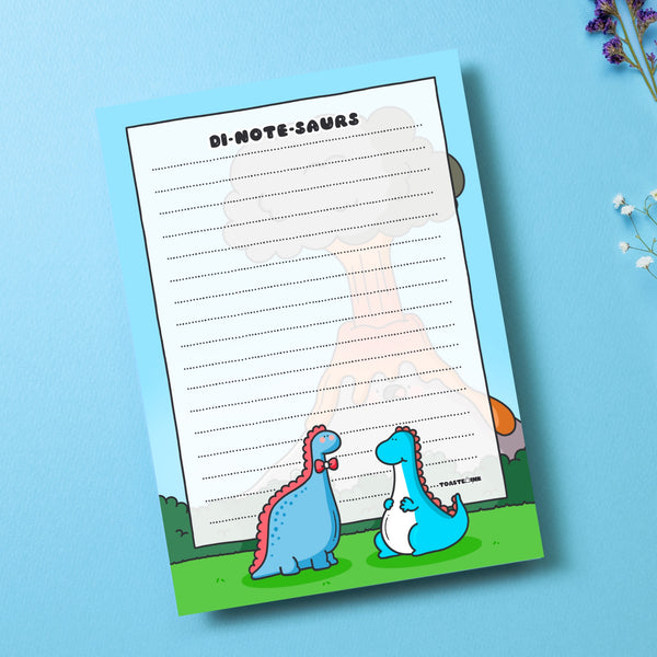 A6 Dinosaur Notepad on blue table with flowers