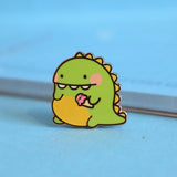 Dinosaur enamel pin on blue table