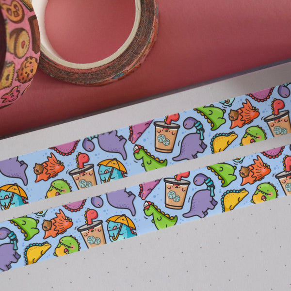 Dinosaur washi tape on notebook and pink table
