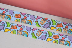Dinosaur washi tape on pink table and notebook