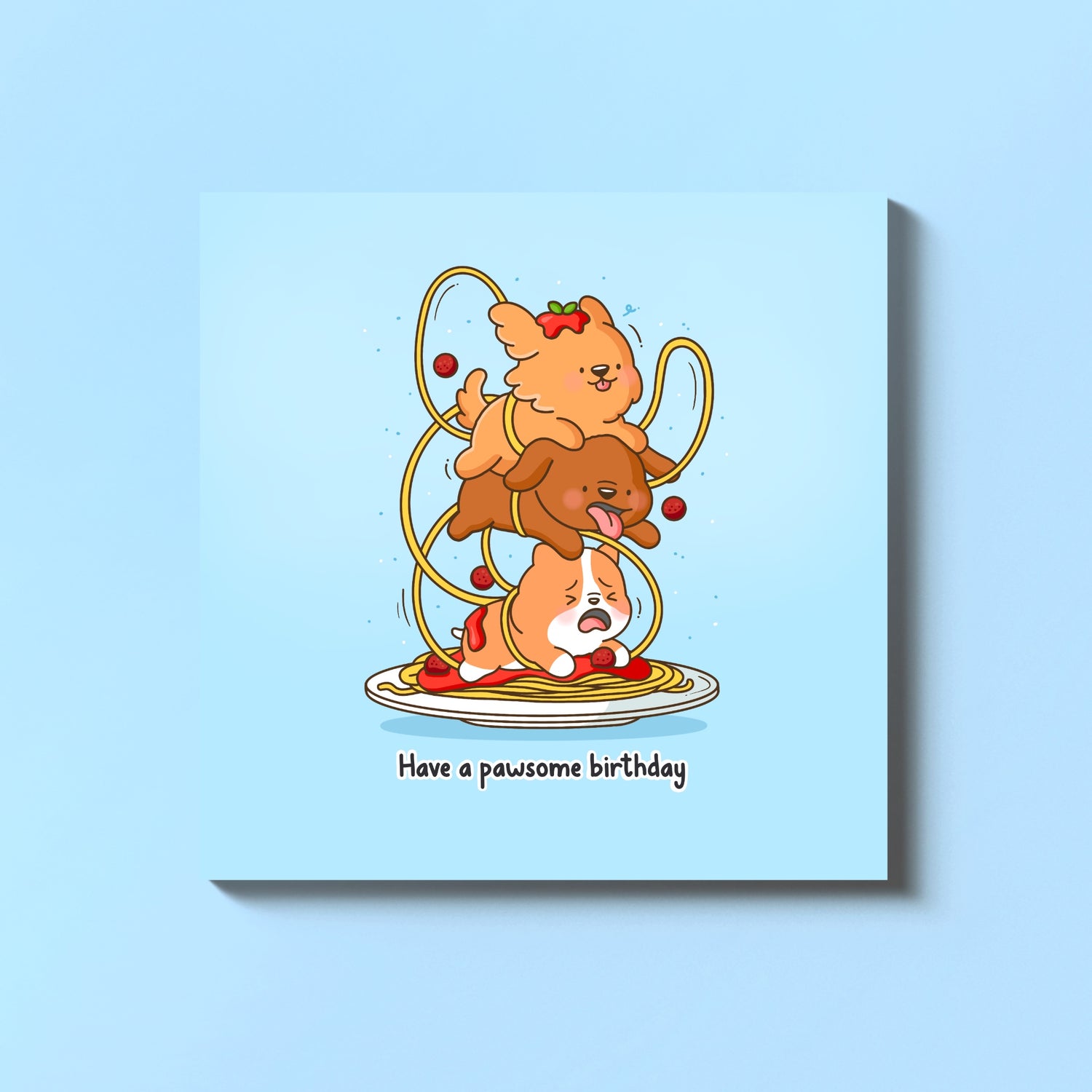 Stack of dogs birthday card on blue table