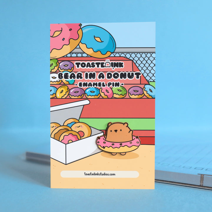 Bear in a donut enamel pin on donut backing card